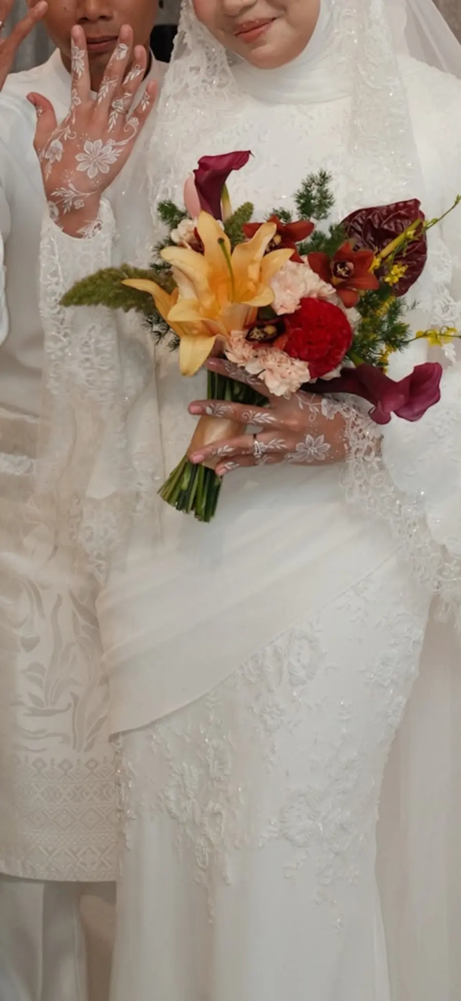 Sarah holding her nikah bouquet